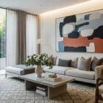 Bright living room with grey sofa, concrete table, green plants. Large windows, balanced Feng Shui elements for positive chi.